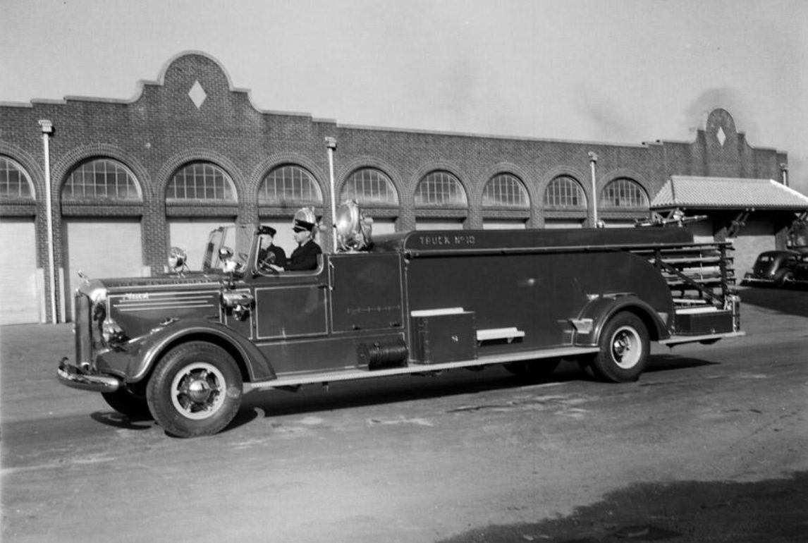 Historic firetruck in front of city garage of Durham